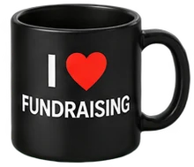 A black mug printed with "I love fundraising"